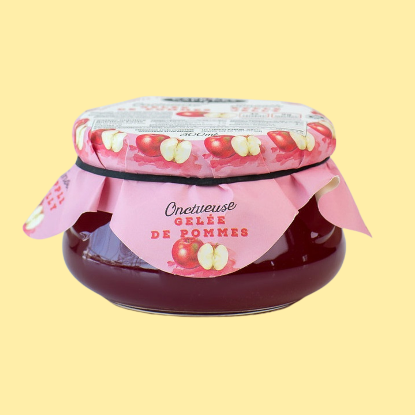 Pot de gelée de pommes onctueuse de la marque Caprices d’Antan. Confiture artisanale présentée dans un pot en verre avec un couvercle décoré d’illustrations de pommes. Produit québécois naturel, parfait pour les déjeuners, desserts et recettes gourmandes.