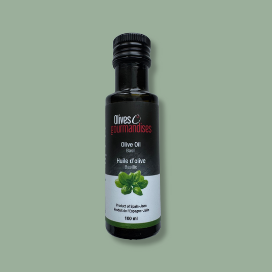Bouteille de 100 ml d'huile d'olive au basilic de la marque Olives et Gourmandises. Produit artisanal issu d'olives de Jaén, Espagne. Parfait pour assaisonner salades, pâtes et plats méditerranéens.