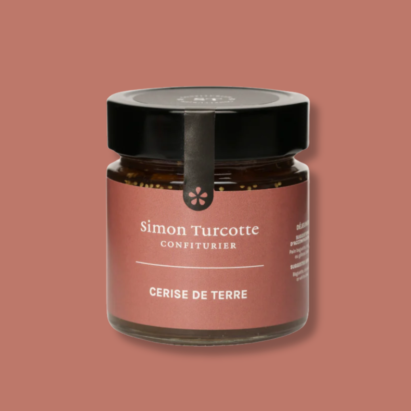 Petit pot de confiture artisanale de cerise de terre signé Simon Turcotte Confiturier. L’emballage élégant présente une étiquette aux tons terre cuite avec un couvercle noir et un sceau décoratif. Un produit raffiné qui met en valeur les saveurs douces et légèrement acidulées de la cerise de terre.